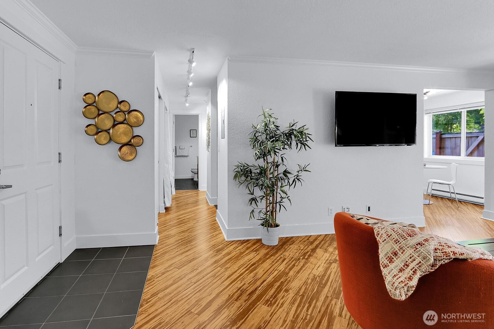 939 North 101st Street, Unit 101 Seattle, WA 98133 - Photo 2 of 13 a living room with furniture and a flat screen tv