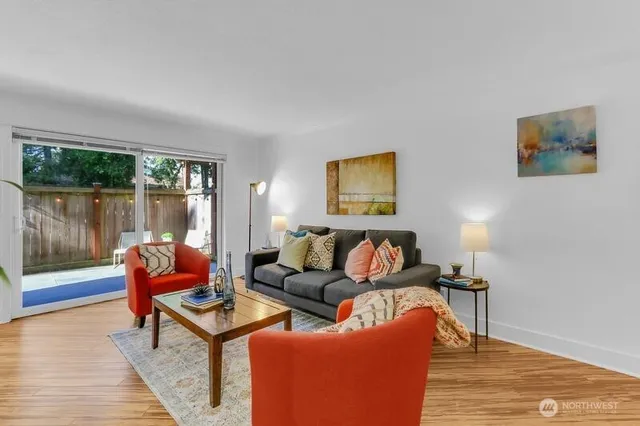 a living room with furniture and a wooden floor