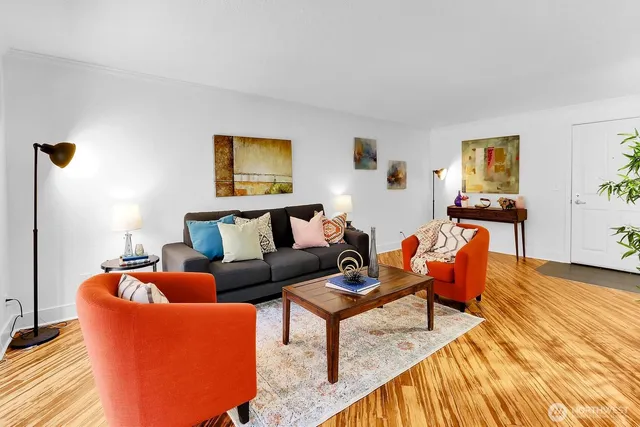 a living room with furniture and wooden floor