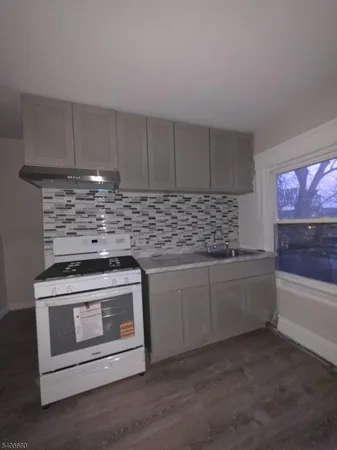 a kitchen with white cabinets and appliances