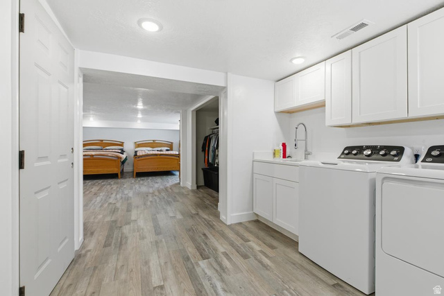 916 North Bonneville Road Preston, ID 83263 - Photo 10 of 37 Laundry area featuring washer and dryer, light wood-style flooring, cabinet space, and recessed lighting