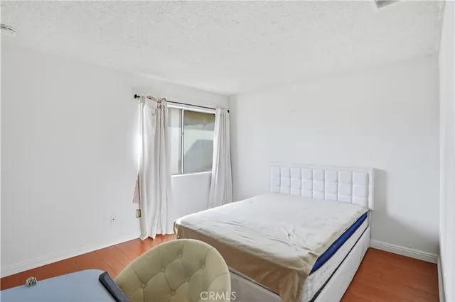 a bedroom with a bed and a chair