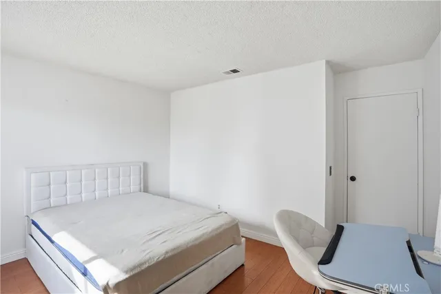 a bedroom with a bed and chair