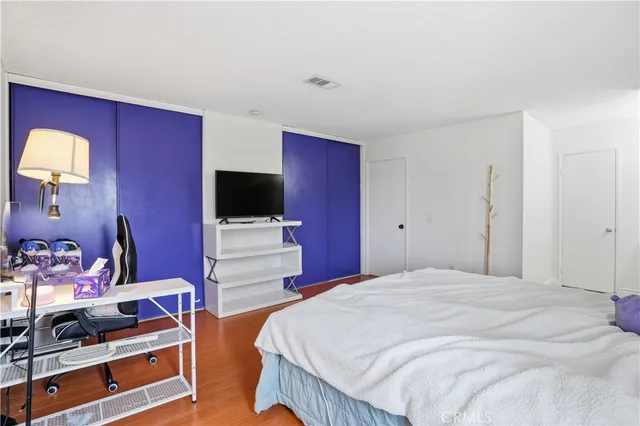 a bedroom with a bed and a flat screen tv