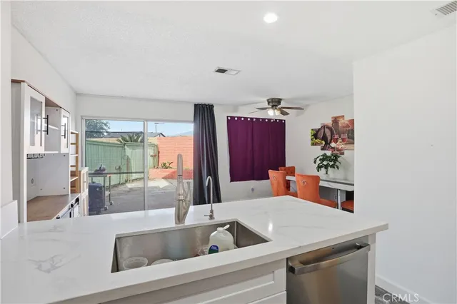a kitchen with a refrigerator and a sink