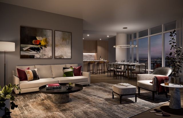 a living room with furniture a rug and a chandelier