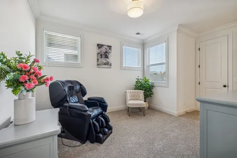 a living room with furniture and flowers