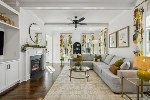 a living room with furniture a fireplace and a chandelier
