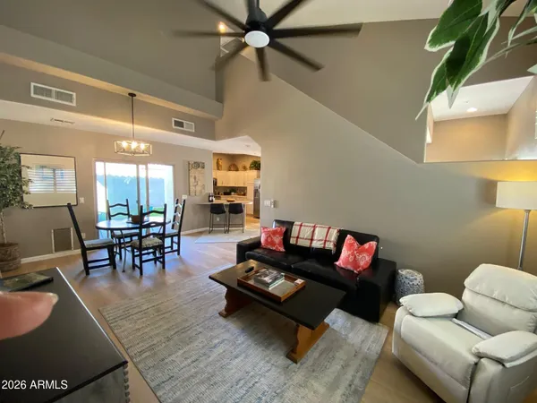 a living room with furniture and wooden floor
