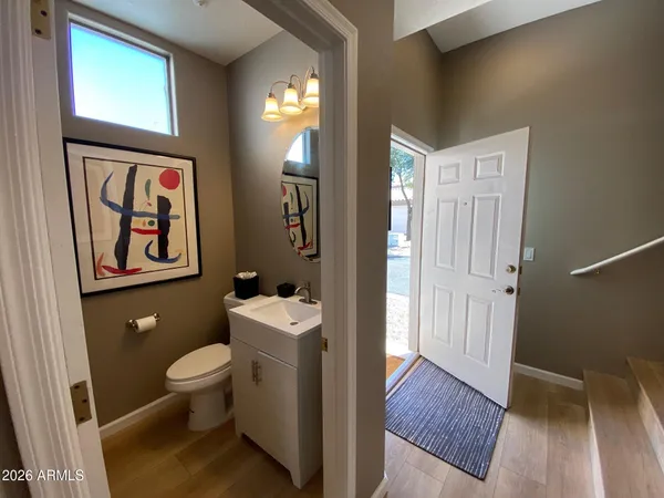 a bathroom with a toilet a sink a vanity and mirror