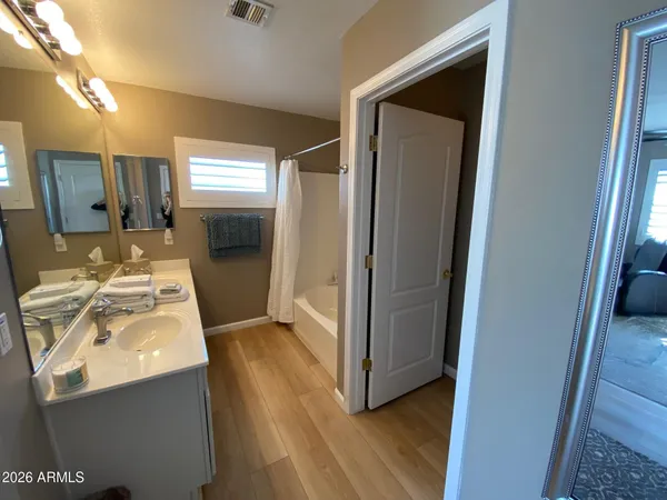 a en suite bathroom with a sink mirror and shower