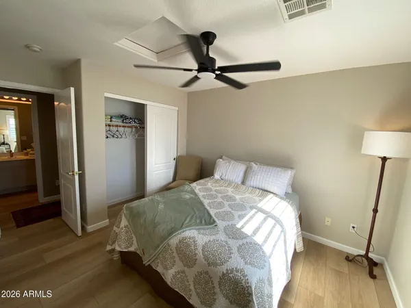 a bedroom with a bed and wooden floor