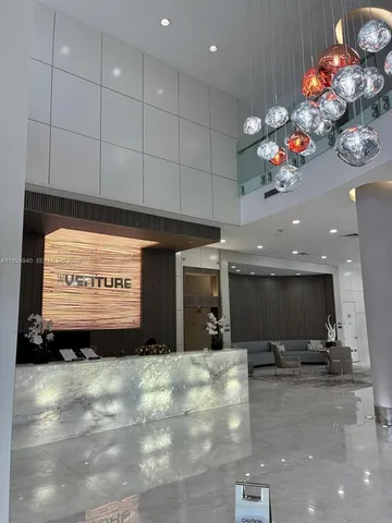 a view of a room with kitchen kitchen island stainless steel appliances sink and living room view