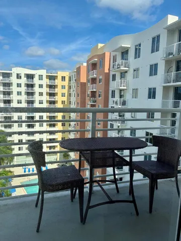 a view of a dining room with furniture and a window