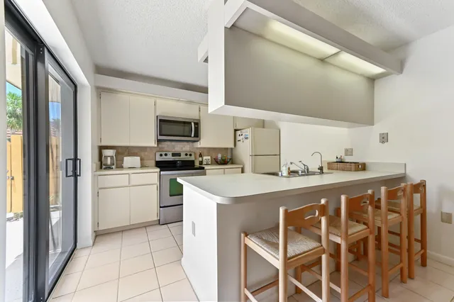 a kitchen with a sink stove and white cabinets