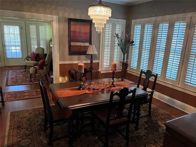 a view of a dining room with furniture and chandelier