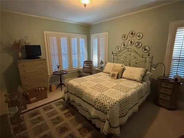 a bed sitting in a bedroom next to a window