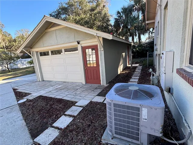 a front view of house with yard and trees in the background