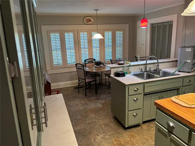 a kitchen with a sink stove and cabinets