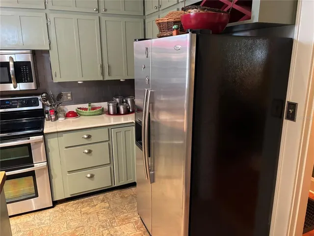 a kitchen with a refrigerator and cabinets