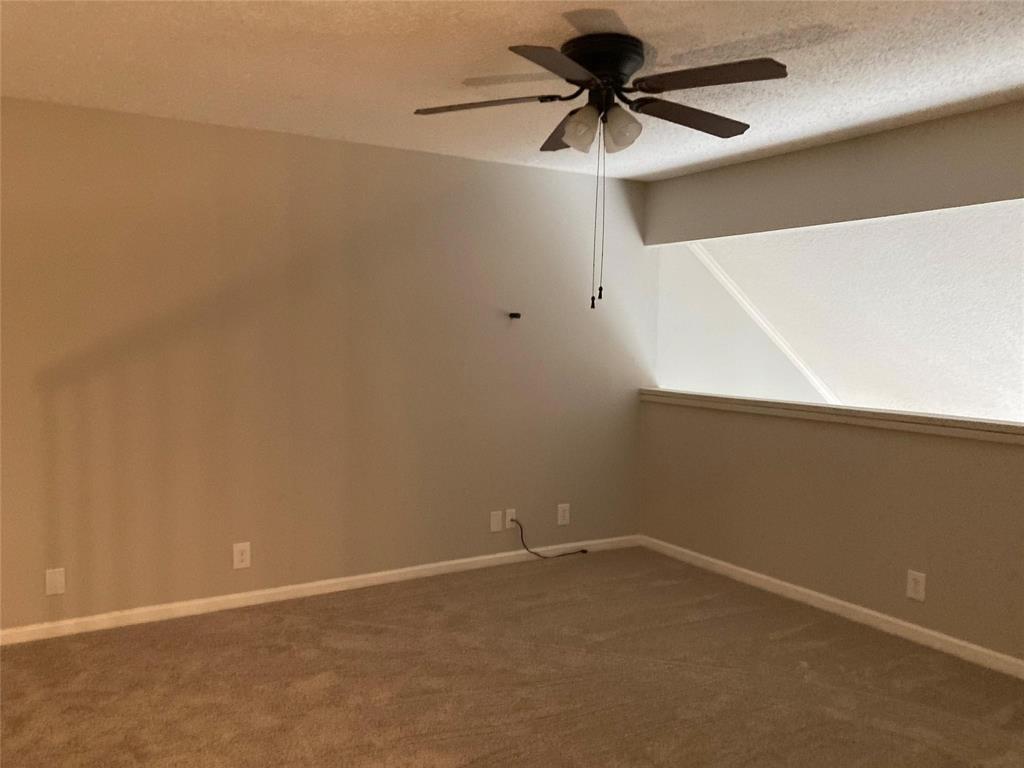 18240 Midway Road, Unit 905 Dallas, TX 75287 - Photo 9 of 15 Carpeted spare room featuring ceiling fan and a textured ceiling