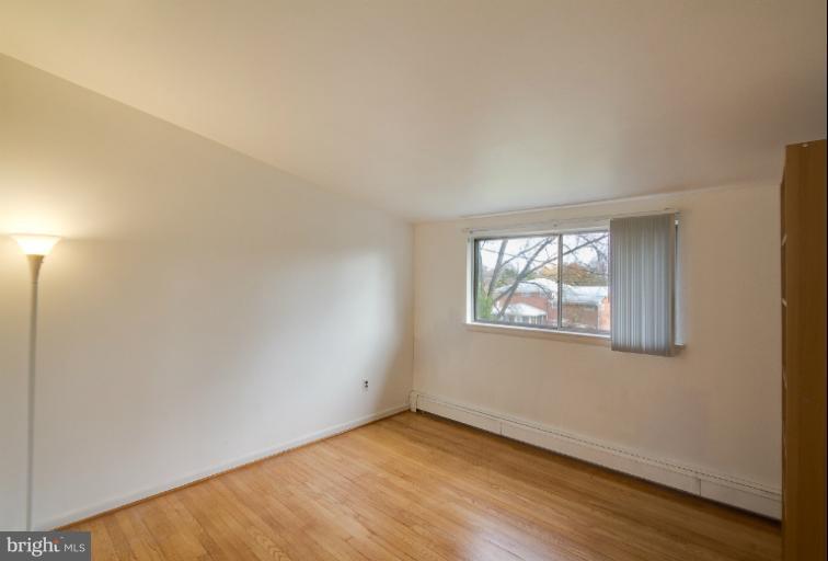 3619 Rusty Rock Road Randallstown, MD 21133 - Photo 17 of 30 an empty room with wooden floor and windows