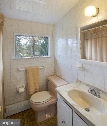 3619 Rusty Rock Road Randallstown, MD 21133 - Photo 19 of 30 a bathroom with a toilet sink and mirror