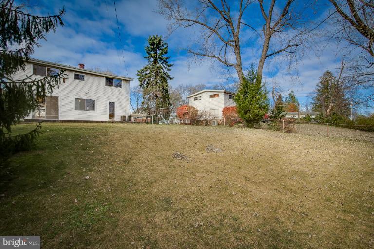 3619 Rusty Rock Road Randallstown, MD 21133 - Photo 29 of 30 a view of a house with a yard and garage