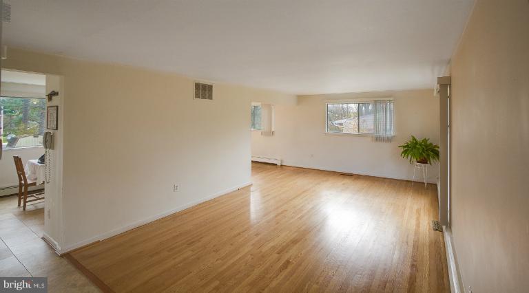 3619 Rusty Rock Road Randallstown, MD 21133 - Photo 6 of 30 a view of a room with wooden floor and a window