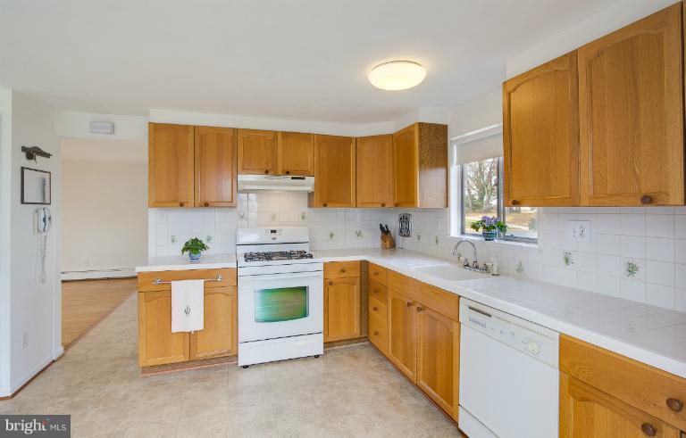 3619 Rusty Rock Road Randallstown, MD 21133 - Photo 7 of 30 a kitchen with stainless steel appliances granite countertop a sink stove and refrigerator