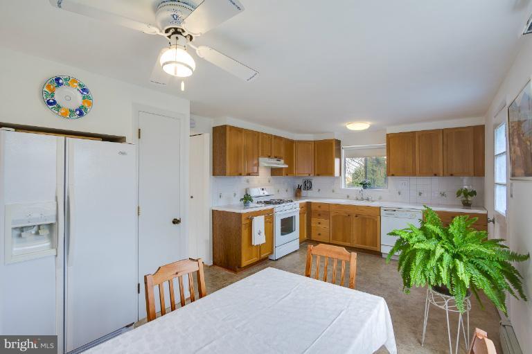 3619 Rusty Rock Road Randallstown, MD 21133 - Photo 8 of 30 a kitchen with a table and refrigerator