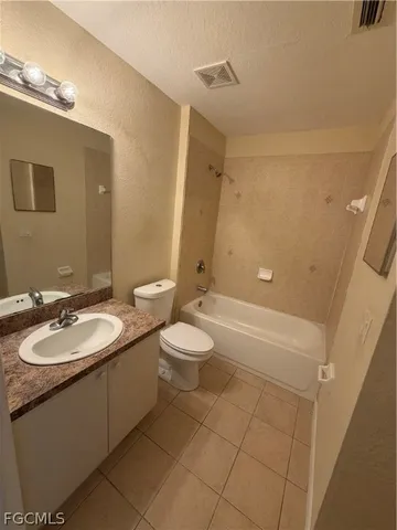 a bathroom with a double vanity sink toilet mirror and shower