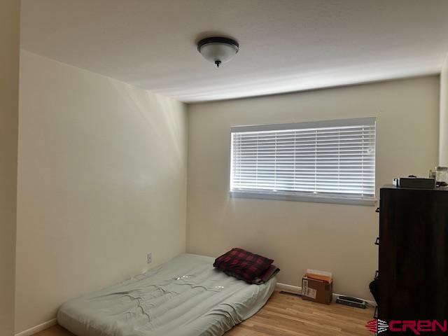 726 East 3rd Street Cortez, CO 81321 - Photo 11 of 20 a bedroom with a bed and a window