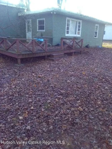 a view of a backyard with large trees