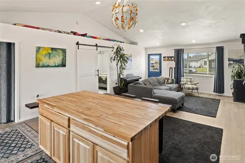a bedroom with a large bed and a chandelier