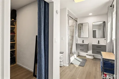 a bathroom with a sink mirror toilet and shower