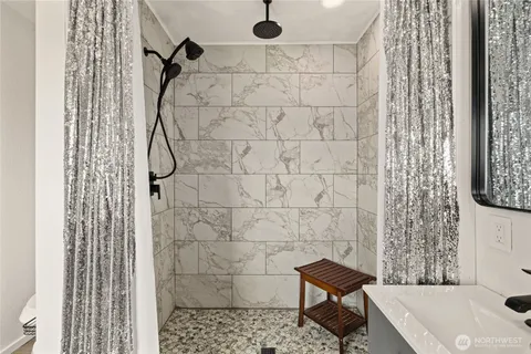 a bathroom with a shower and a toilet