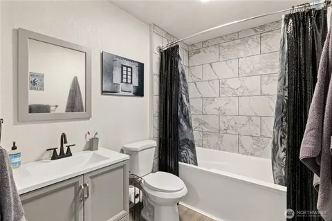 a bathroom with a sink toilet and shower