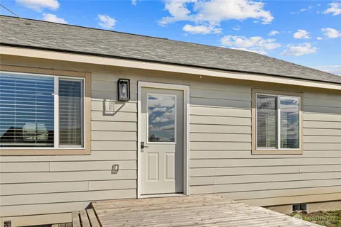 a view of a house with a door and wooden floor