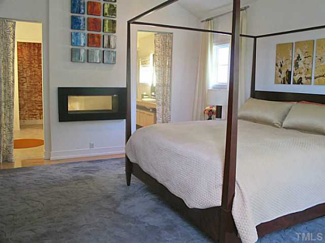 2108 Blue Oak Terrace Raleigh, NC 27608 - Photo 13 of 25 a bedroom with a bed and a flat screen tv