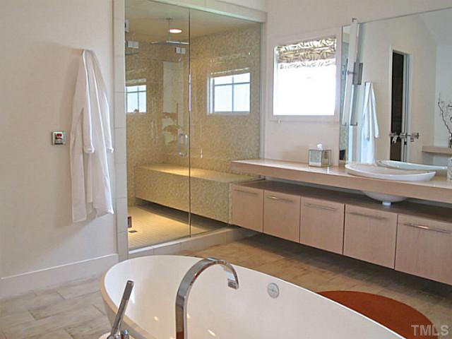 2108 Blue Oak Terrace Raleigh, NC 27608 - Photo 15 of 25 a en suite bathroom with a sink mirror and a bathtub