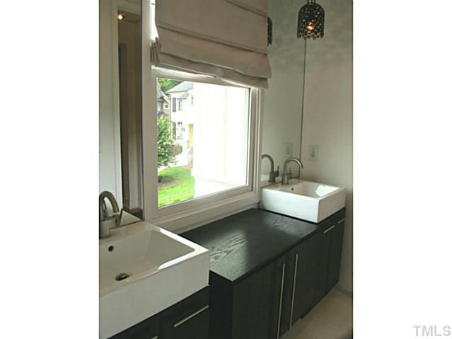 2108 Blue Oak Terrace Raleigh, NC 27608 - Photo 19 of 25 a bathroom with a sink and a window