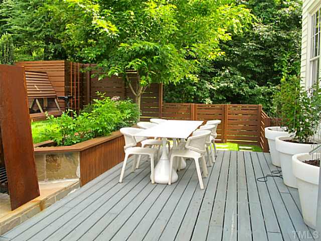 2108 Blue Oak Terrace Raleigh, NC 27608 - Photo 22 of 25 a view of deck with table and chairs potted plants with wooden floor