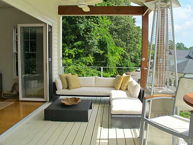 2108 Blue Oak Terrace Raleigh, NC 27608 - Photo 8 of 25 a view of a balcony with couch and wooden floor