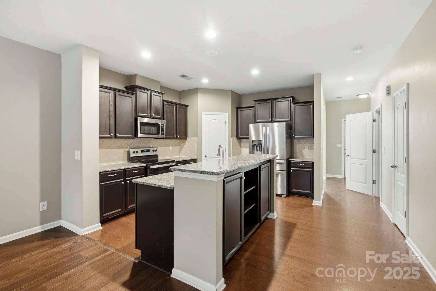 8988 Lanark Lane Fort Mill, SC 29707 - Photo 11 of 43 a kitchen with stainless steel appliances granite countertop a refrigerator stove and sink