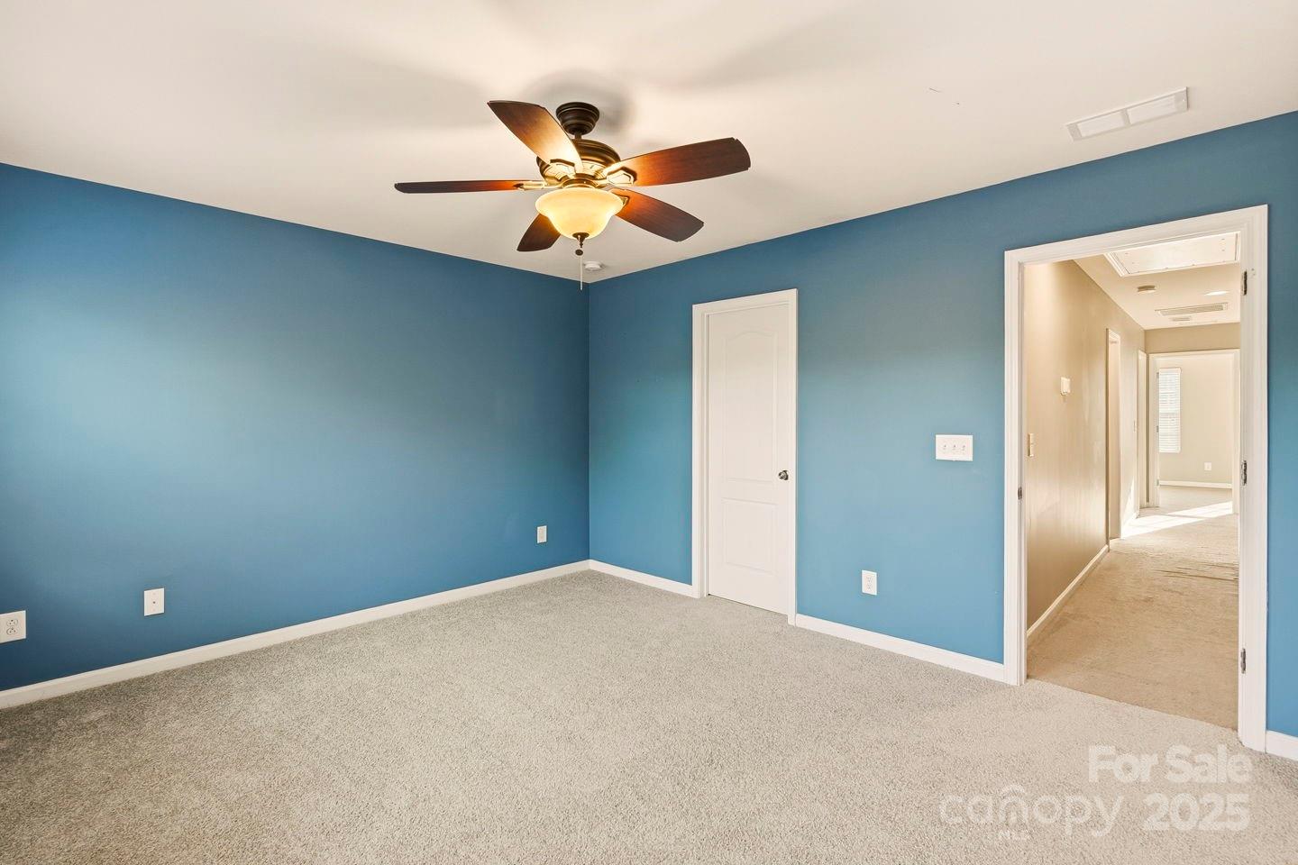8988 Lanark Lane Fort Mill, SC 29707 - Photo 27 of 43 a view of an empty room with a chandelier fan