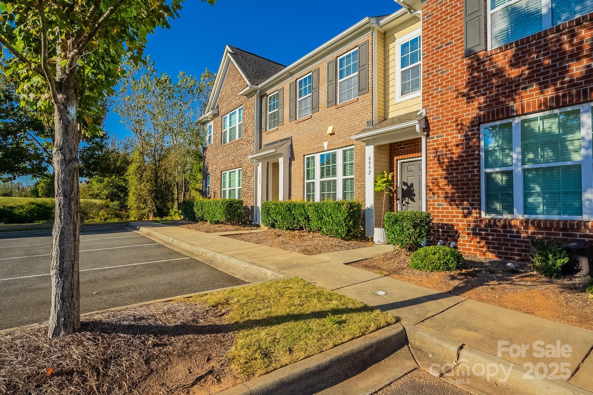 8988 Lanark Lane Fort Mill, SC 29707 - Photo 3 of 43 a view of a brick building next to a yard