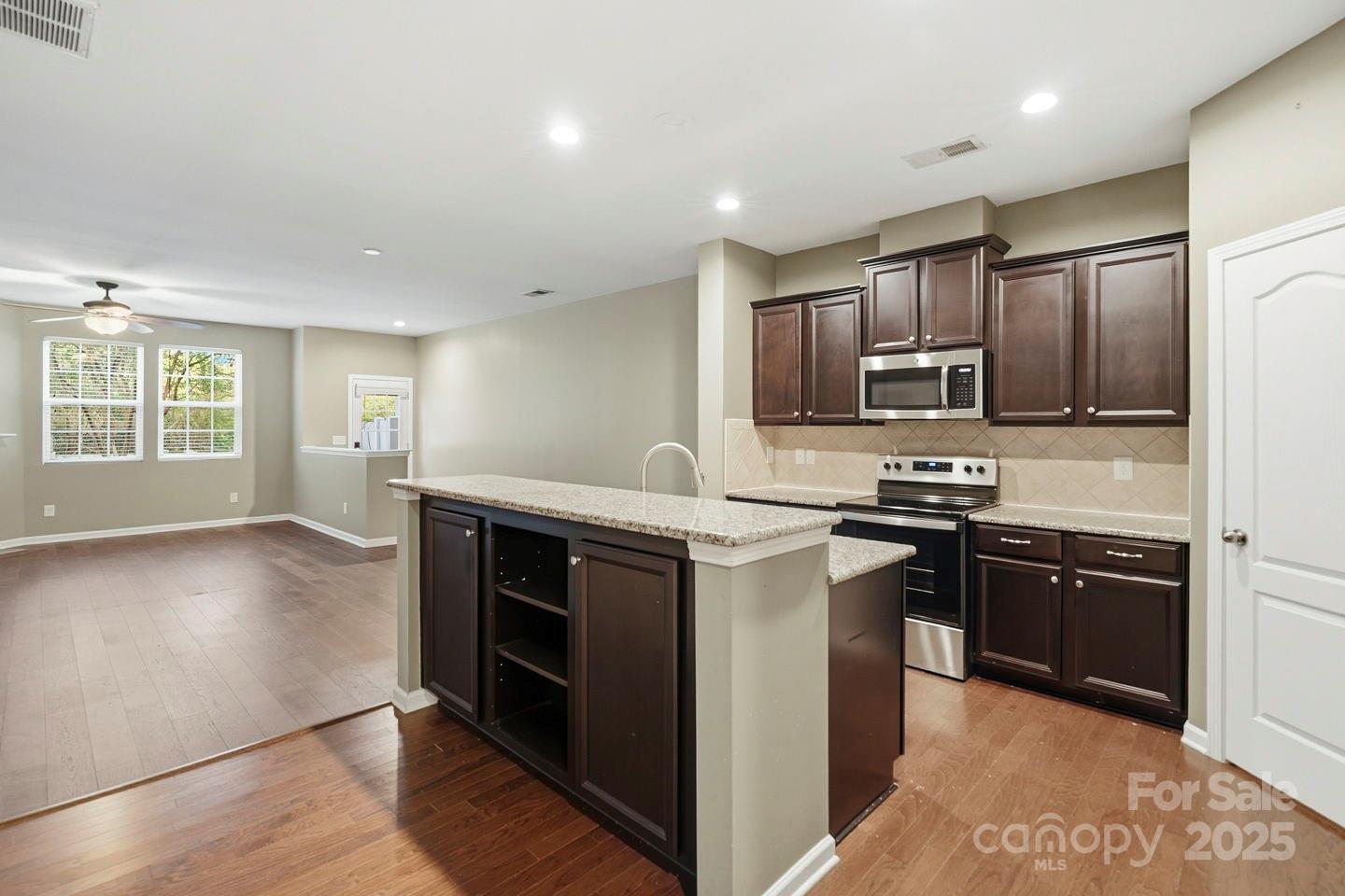 8988 Lanark Lane Fort Mill, SC 29707 - Photo 10 of 43 a kitchen with stainless steel appliances granite countertop a stove a sink and a refrigerator