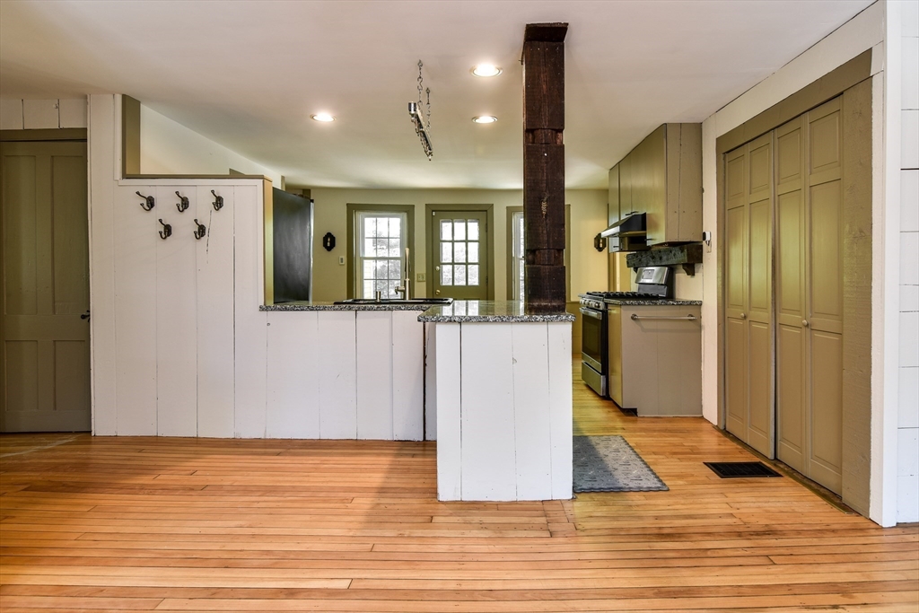 33 Grove Street Framingham, MA 01701 - Photo 5 of 33 a view of a kitchen with refrigerator and wooden floor
