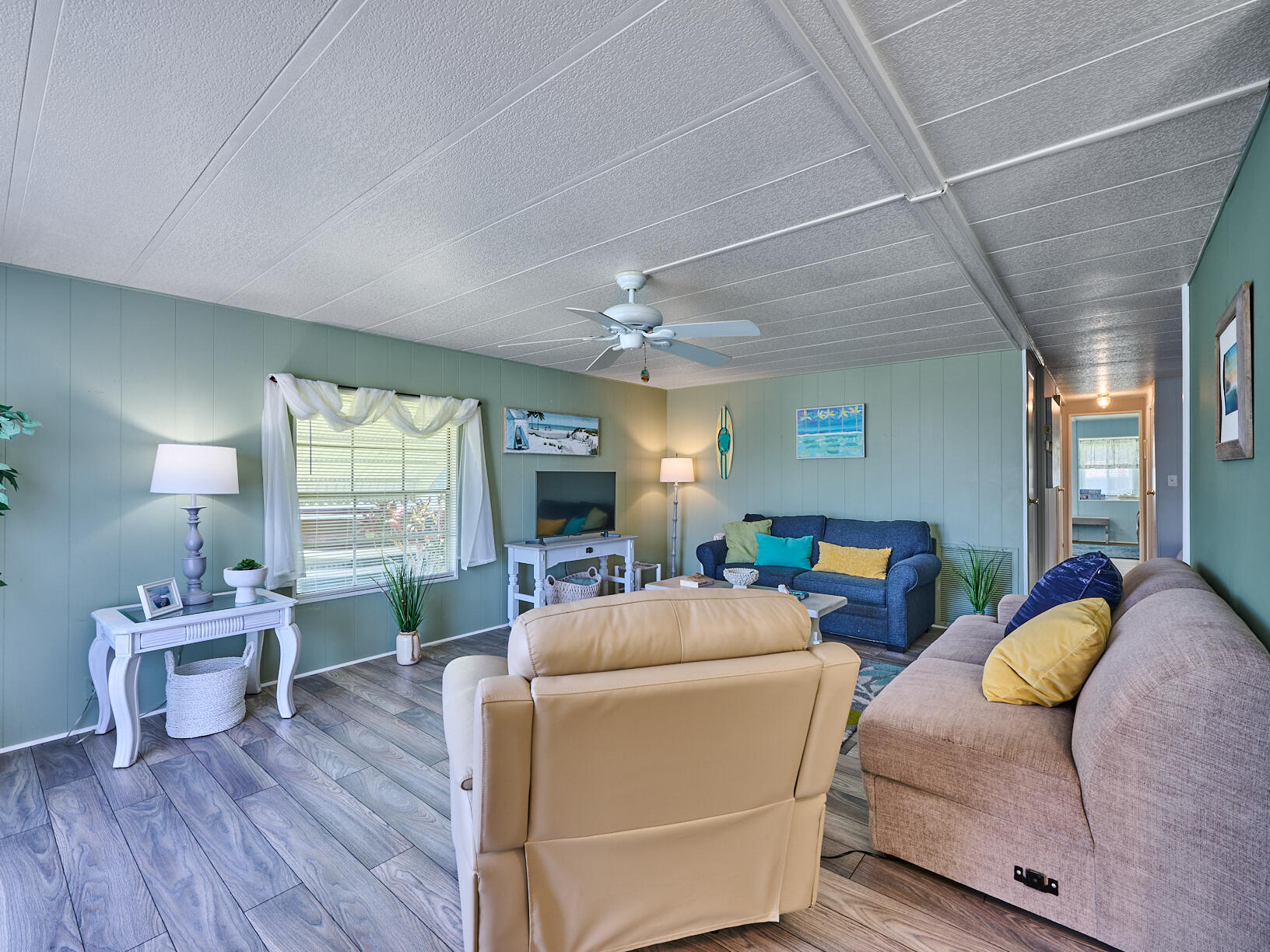 6977 Southeast Delegate Street Hobe Sound, FL 33455 - Photo 23 of 60 a living room with furniture and a wooden floor